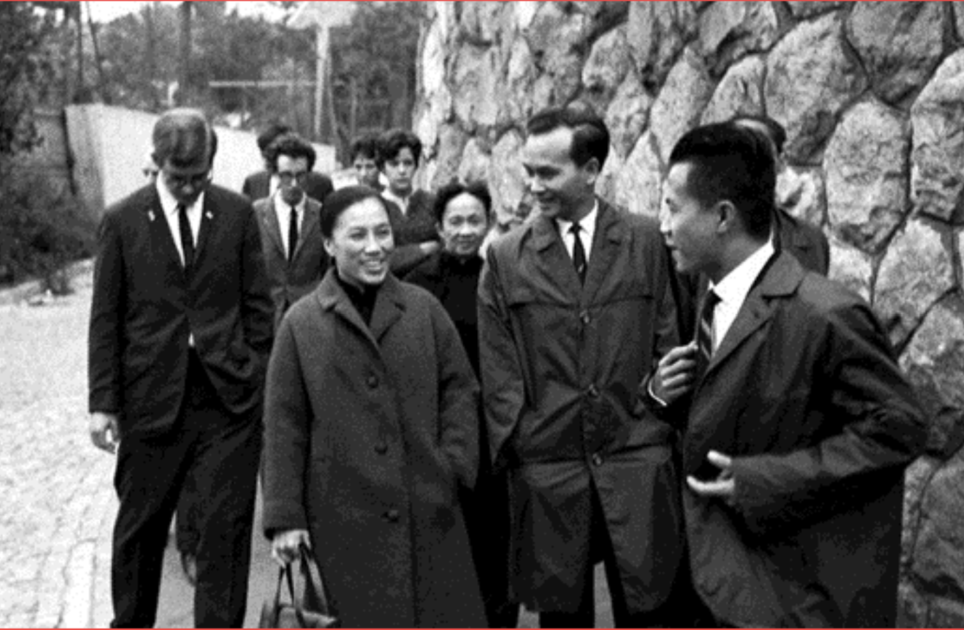 Nguyễn Thị Bình , one of the few women politicians surrounded by a pack of other politicians in a street