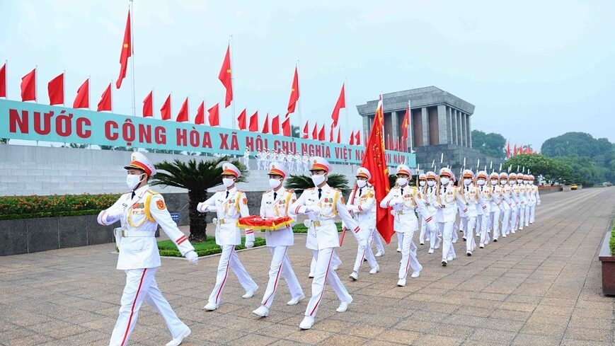 Group of Vietnamese honor guards marching throug Ba Dinh Square in Hanoi