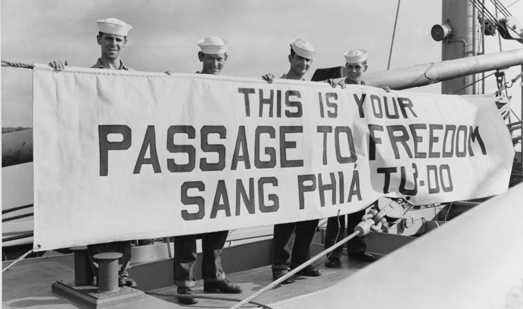 US imperialist navy soliders carry this is your passage to freedom banner